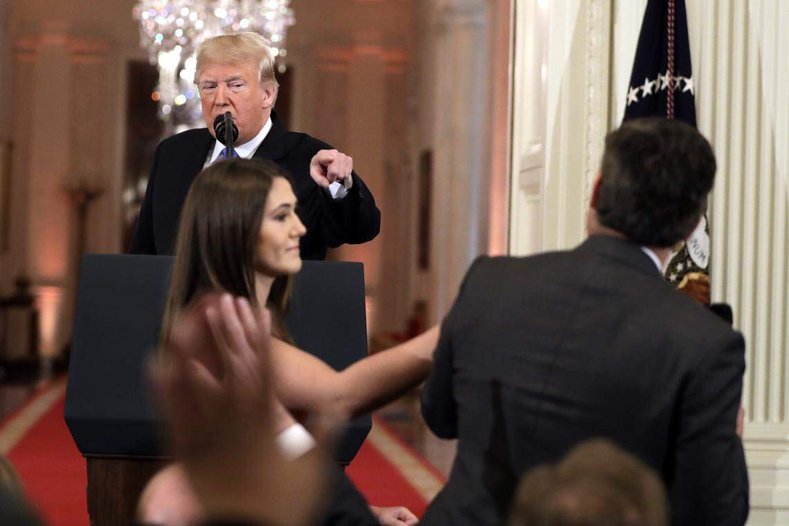 President Donald Trump, a White House intern, and CNN’s Jim Acosta.