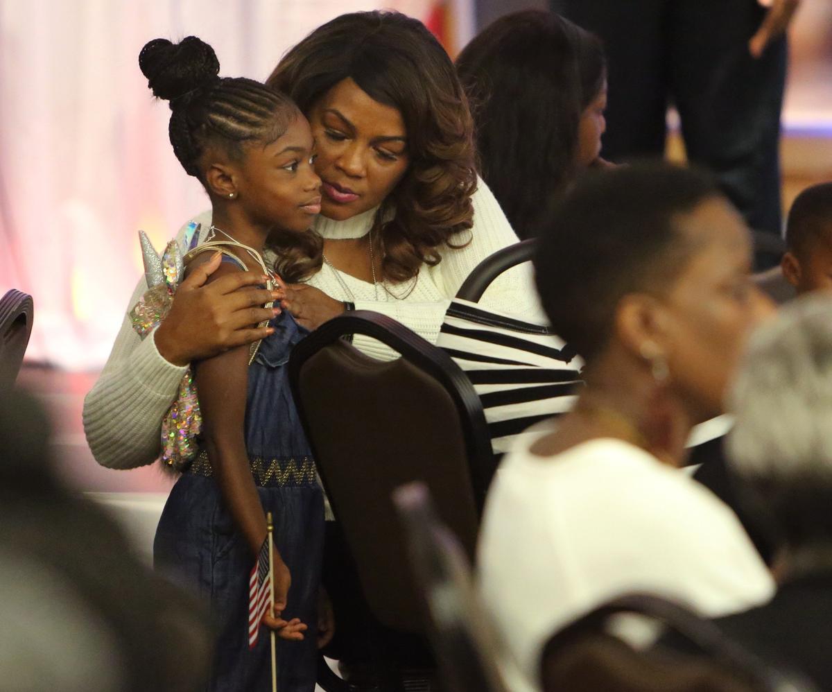Cowanda Johnson, mother of fallen Army Sgt. La David T. Johnson, hugs her granddaughter, Ah'leesya Johnson, 6, during the Memorial Day breakfast at the Betty T. Ferguson Recreational Complex in Miami Gardens.