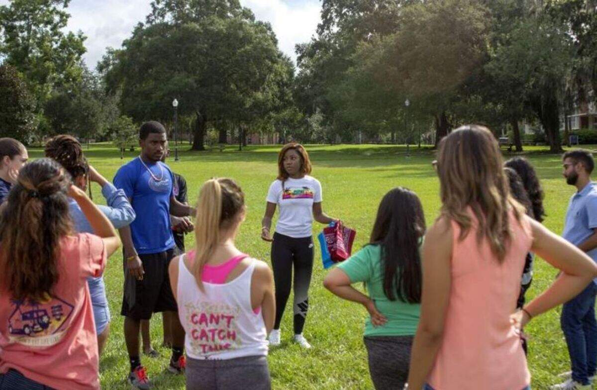 University of Florida student Tyra Striker, center, explains a team-building exercise to students at the Bridges Minority Outreach retreat on campus recently