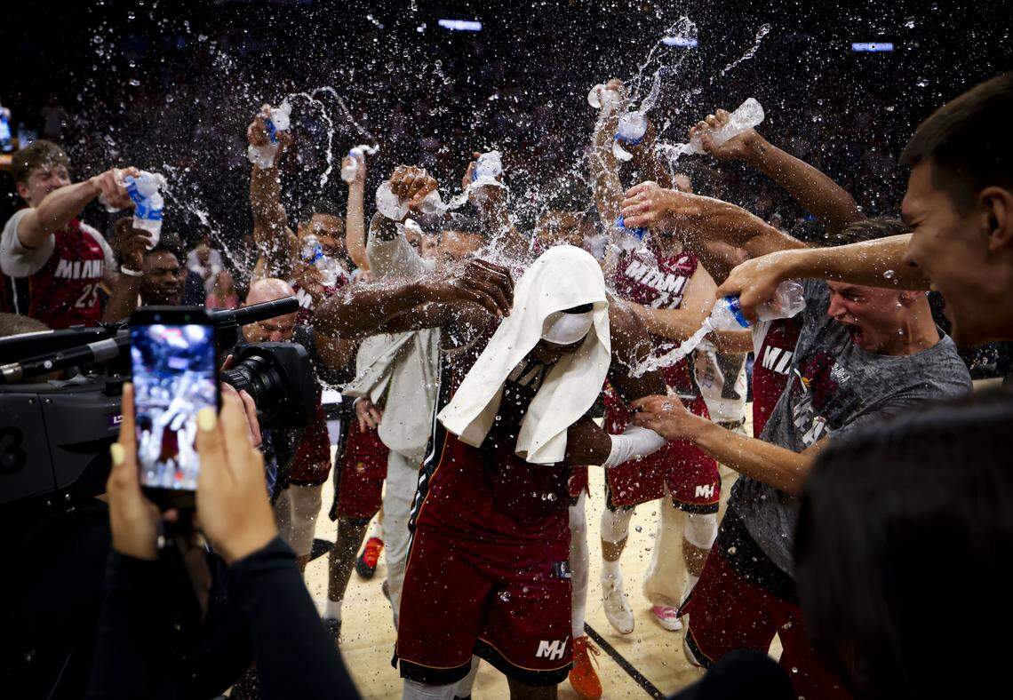 Miami Heat center Bam Adebayo (13) gets water poured on him by his teammates after he scored 83 points against the Washington Wizards, marking the second-highest single-game point total in NBA history, on March 10, 2026, at Kaseya Center in Miami.