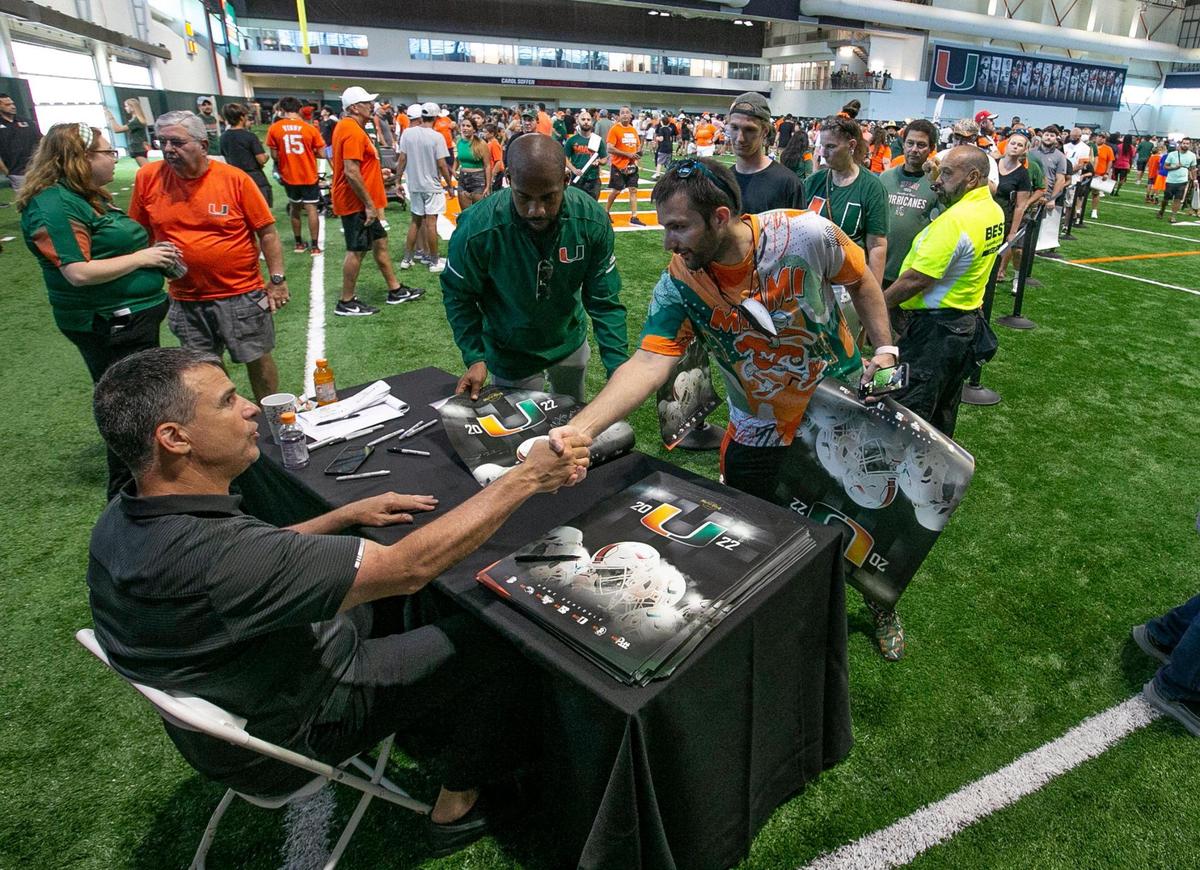 Miami Hurricanes coach Mario Cristobal greets Canes fans at Carol Soffer Indoor Practice Facility during CanesFest at the University of Miami in Coral Gables on Saturday, August 6, 2022.