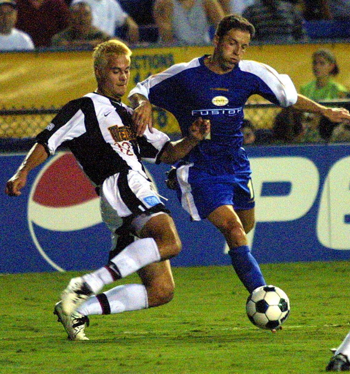 Miami Fusion's Preki, right, fights for the ball against New York/New Jersey Metrostar's Mike Petke during a match at Fort. Lauderdale's Lockhart Stadium.