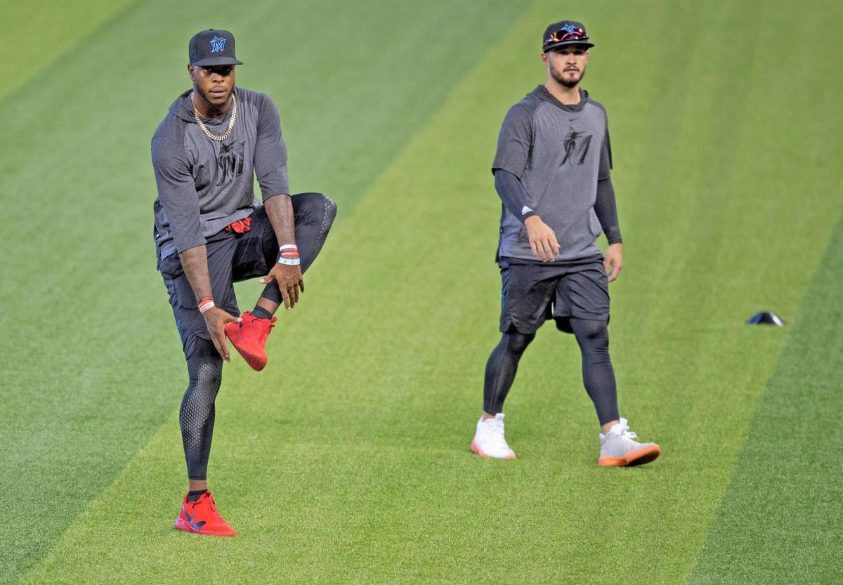 Miami Marlins outfielder Monte Harrison (left) and Eddy Alvarez warm up on the first day of Marlins training camp at Marlins Park on Friday, July 3, 2020.