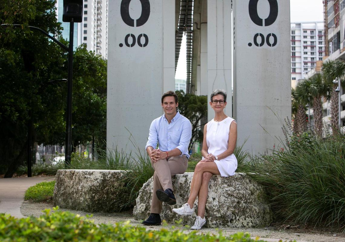 Kieran Bowers, President of Swire Properties and Vice Chair of the nonprofit Friends of the Underline (left), sits with Meg Daly, Friends of the Underline founder, at the mile-zero start of the newly opened Brickell Backyard section of the linear park and urban trail at the Miami River. The half-mile section of the planned 10-mile Underline is the first to be completed.