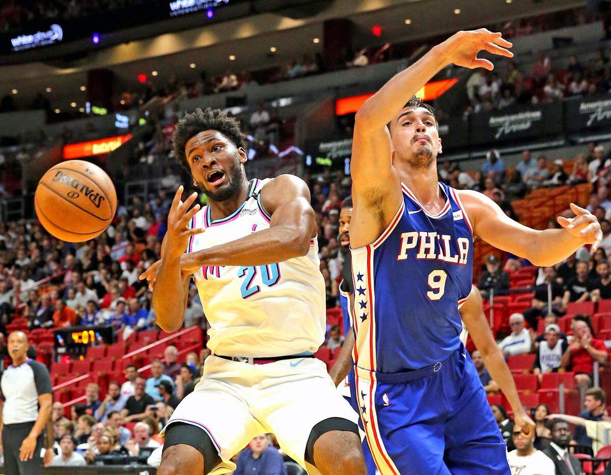 Miami Heat Justise Winslow loses the ball as Philadelphia 76ers Dario Sanic defends in the first quarter at the AmericanAirlines Arena in Miami, Florida, February 27, 2018.