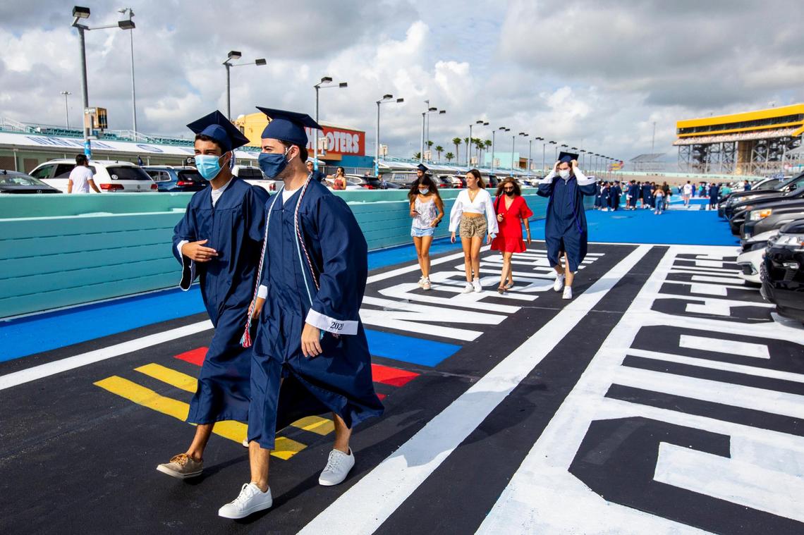 Seniors reunite with friends before the Christopher Columbus High School senior graduation ceremony at Homestead-Miami Speedway, in Homestead, Florida on Saturday, June 20, 2020.