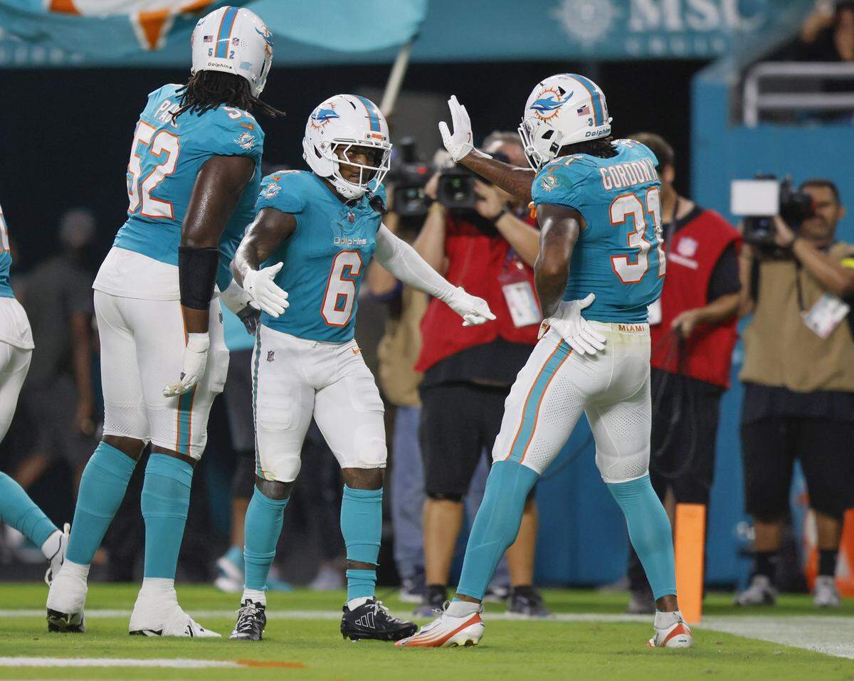 Miami Dolphins wide receiver Malik Washington (6) celebrates in the endzone with teammates after scoring in the first half against the Jacksonville Jaguars during an NFL football game at Hard Rock Stadium in Miami Gardens, Florida, on Saturday, August 23, 2025.