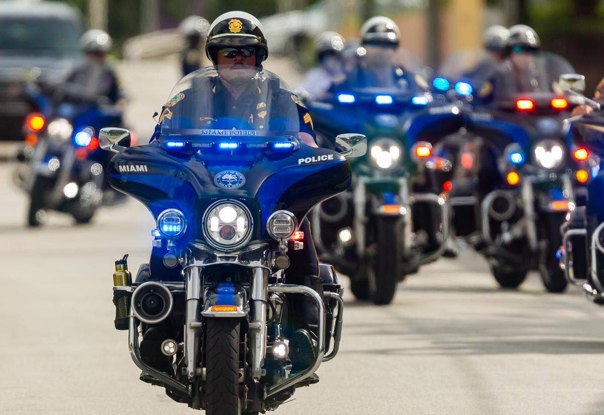 Police escort Democratic presidential nominee Joe Biden as he arrives to speak at Little Havana’s Jose Marti Park in Miami, Florida, on Monday, Oct. 5, 2020.