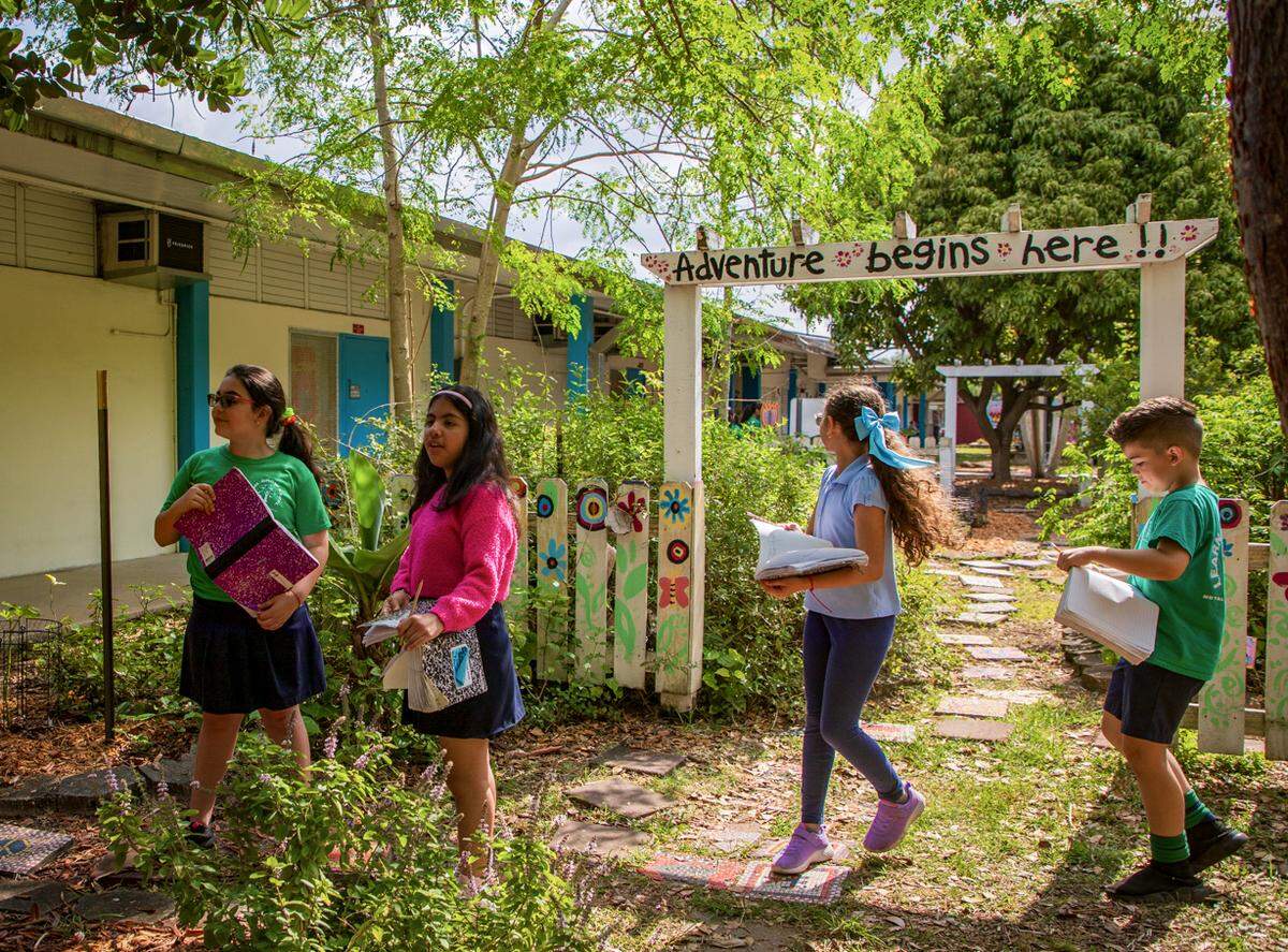 Students walk the garden writing down what they see in the Food Forest at Royal Palm Elementary School on April 22, 2024. Royal Palm Elementary is one of 30 public elementary schools in Miami-Dade Schools with a food forest maintained by the Education Fund.