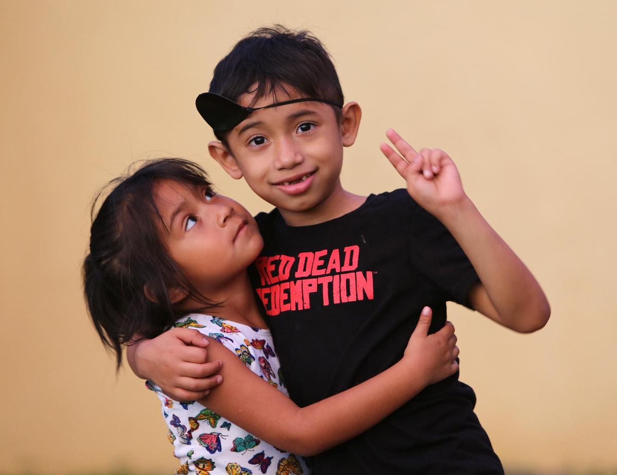 Isabella Morales, 4, hugs her brother and best friend, 7-year-old Julian Morales outside of their Homestead home, Wednesday, Sept. 26, 2018. Julian has a rare genetic disorder and is in need of a bone marrow transplant, but finding a match has been a challenge.