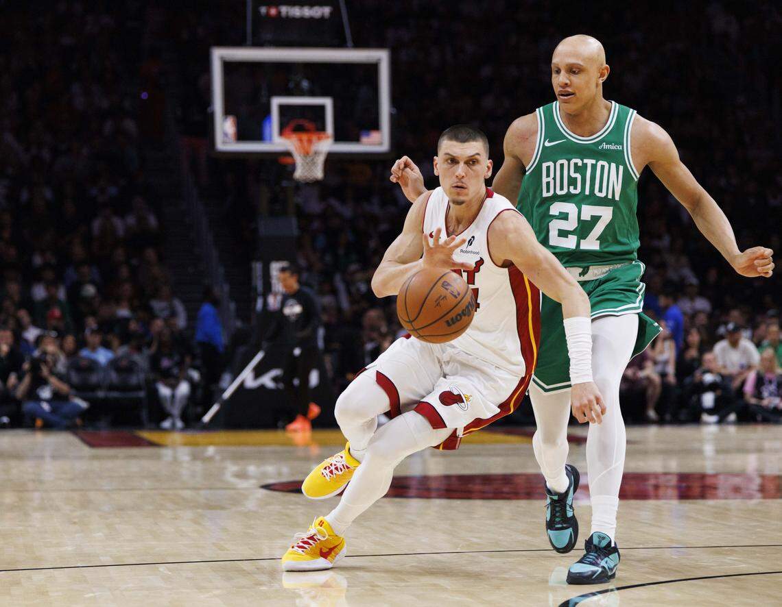 Miami Heat guard Tyler Herro (14) dribbles the ball around Boston Celtics guard Jordan Walsh (27) during the first half of a game on Wednesday, April 1, 2026, at the Kaseya Center in downtown Miami, Fla.