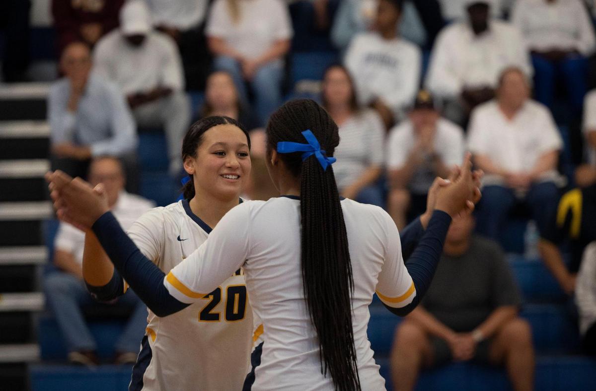 Raiders Mikayla Porter (20) does a handshake with Zori Brown (6) before the regional volleyball championship between Lourdes Academy and St. Thomas Aquinas on Wednesday, Nov. 1, 2023, at St. Thomas Aquinas School in Fort Lauderdale.