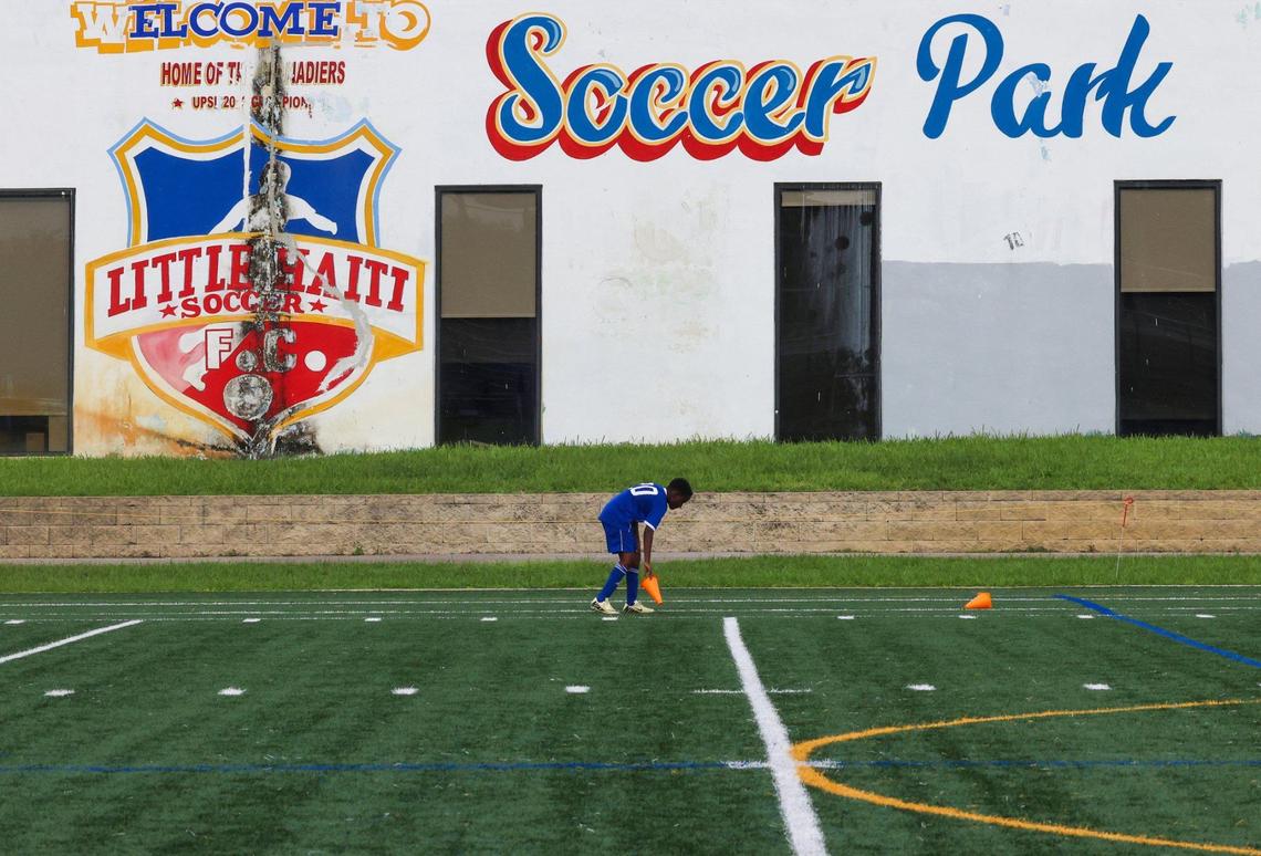 Randy Petit Frere picks up field cones as practice ends for the Little Haiti FC at the Little Haiti Soccer Park in Miami.
