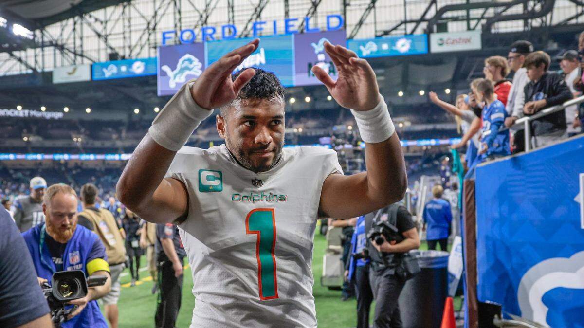 Miami Dolphins quarterback Tua Tagovailoa (1) celebrates as he walks off the field after the Dolphins defeat the Detroit Lions at Ford Field in Detroit, Michigan on Sunday, October 30, 2022.