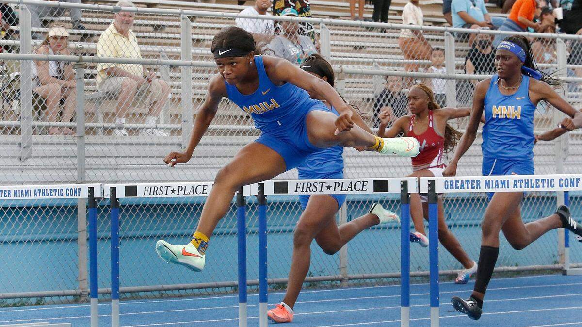 Northwestern’s Paris Baker wins girls 100 meter hurdles during the GMAC Track and Field Championship on Thursday, April 7, 2022 at Traz Powell Stadium in Miami. Andrew Uloza / for THE MIAMI HERALD