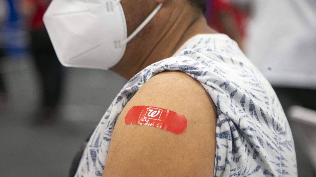 A COVID-19 vaccine recipient sports a Walgreens Band-Aid after his vaccine is administered at the South Mountain Community College in Phoenix on April 10, 2021.

South Mountain Vaccine Event