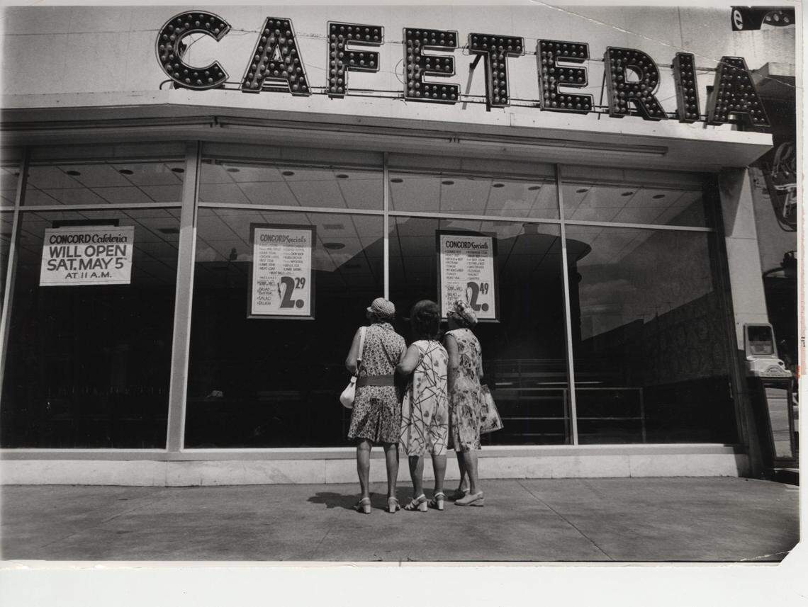 In 1973, customers peer into the Concord Cafeteria in South Beach while the restaurant was under repairs after a firebombing.