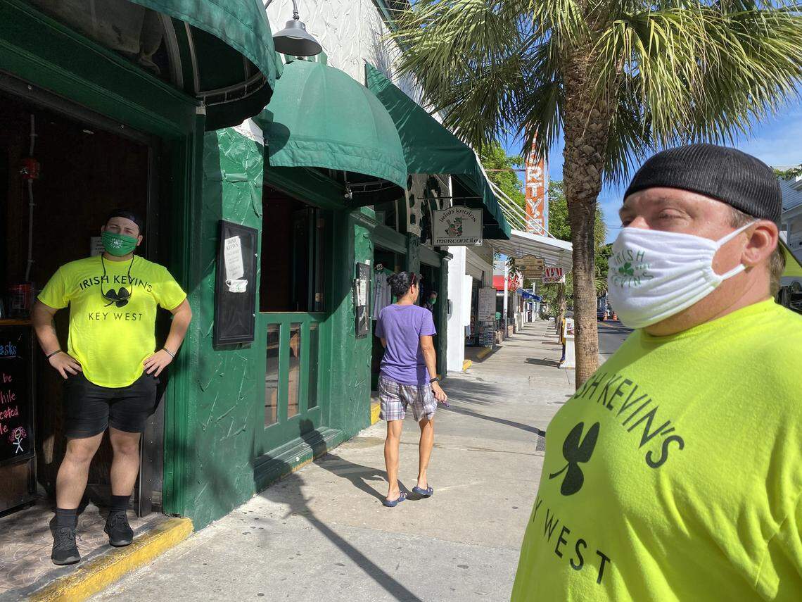 Employees of Irish Kevin’s bar in Key West wear face masks on June 1, 2020, the day the Florida Keys officially reopened to tourists.
