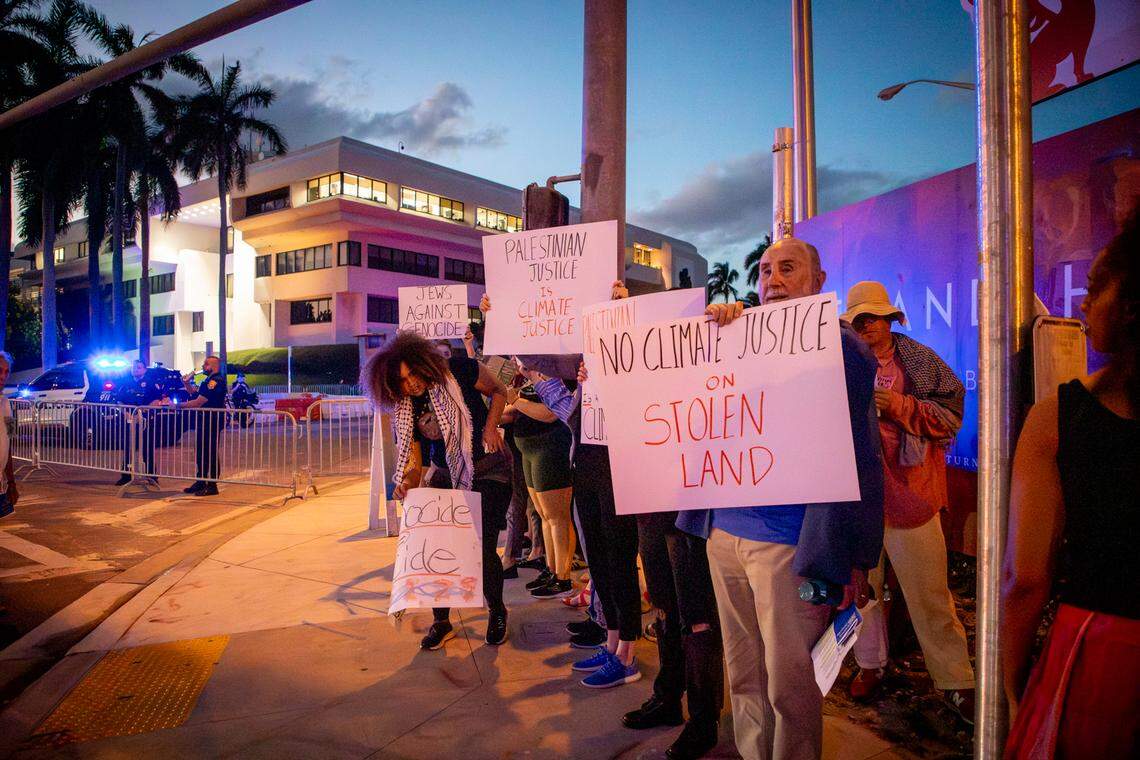 Pro-Palestinian protesters moved to the sidewalk across from the 17th Street parking garage after being told by police they couldn’t stand outside the Miami Beach Botantical Garden across from a climate conference at the Convention Center.