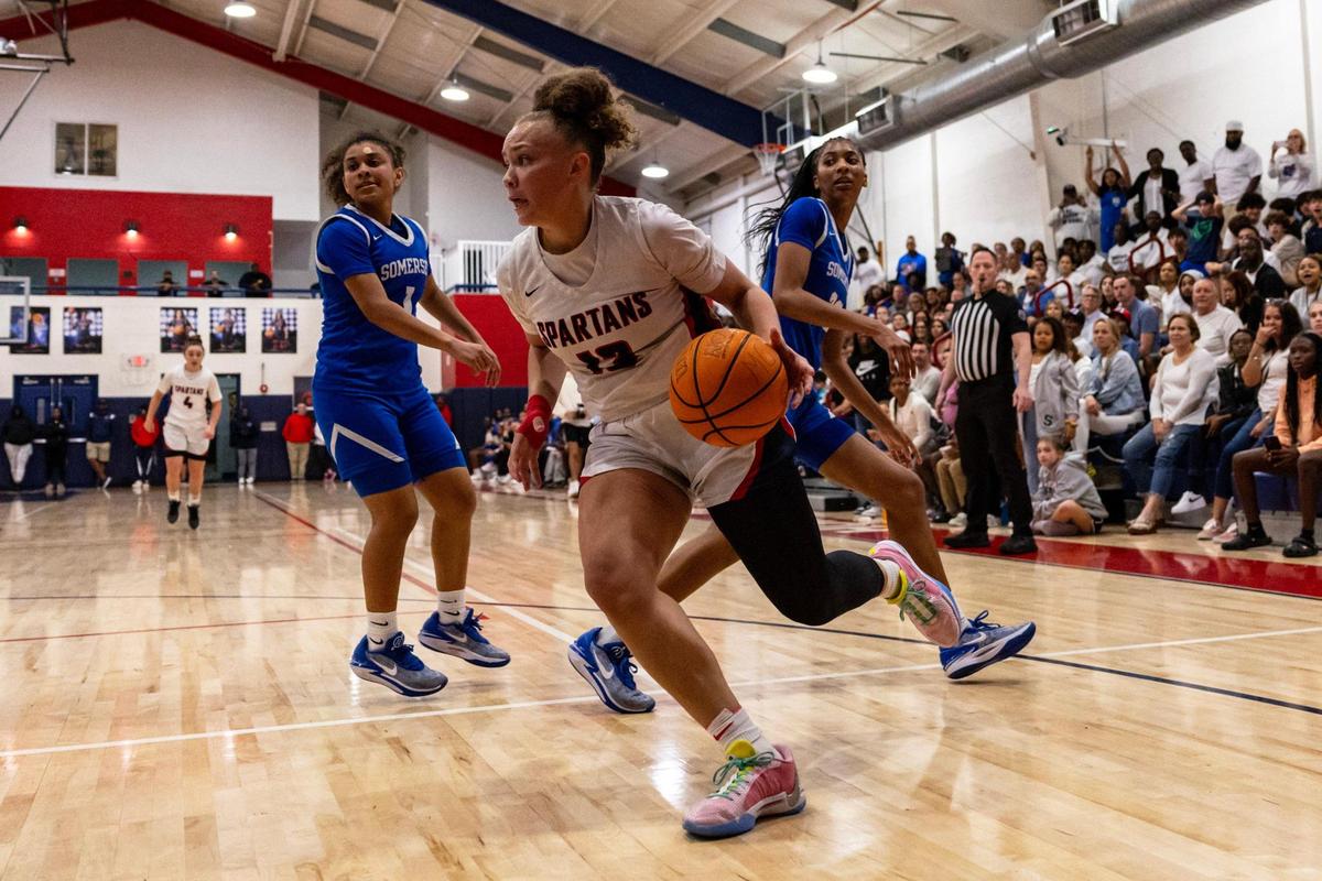 Miami Country Day forward Jalynn Belton (13) drives past Somerset guard Isyss Mims (14) and forward Riley Stoker (23) during a Regional 4-3A girls basketball final at Miami Country Day School in Miami, Florida on Thursday, February 22, 2024.