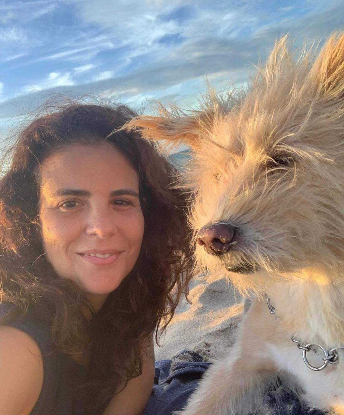 A photo of Flavia Carnicelli, a Miami Beach chef who was struck and killed by a motorist last year when she was riding her bike to work. She’s with her dog, Carmela.