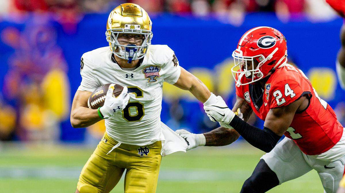 Jan 2, 2025; New Orleans, LA, USA; Notre Dame Fighting Irish wide receiver Jordan Faison (6) is tackled by Georgia Bulldogs defensive back Malaki Starks (24) during the second half at Caesars Superdome.