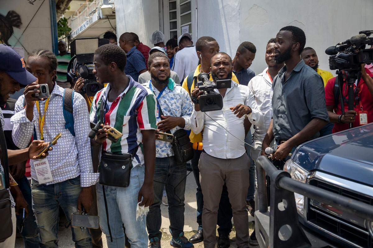 Haitian Journalists in August 2024 wait for then-Haitian Prime Minister Garry Conille to arrive at Bernard Mevs Hospital to visit wounded policemen. Months later, Conille would be replaced and the hospital burned and pillaged by armed gangs.