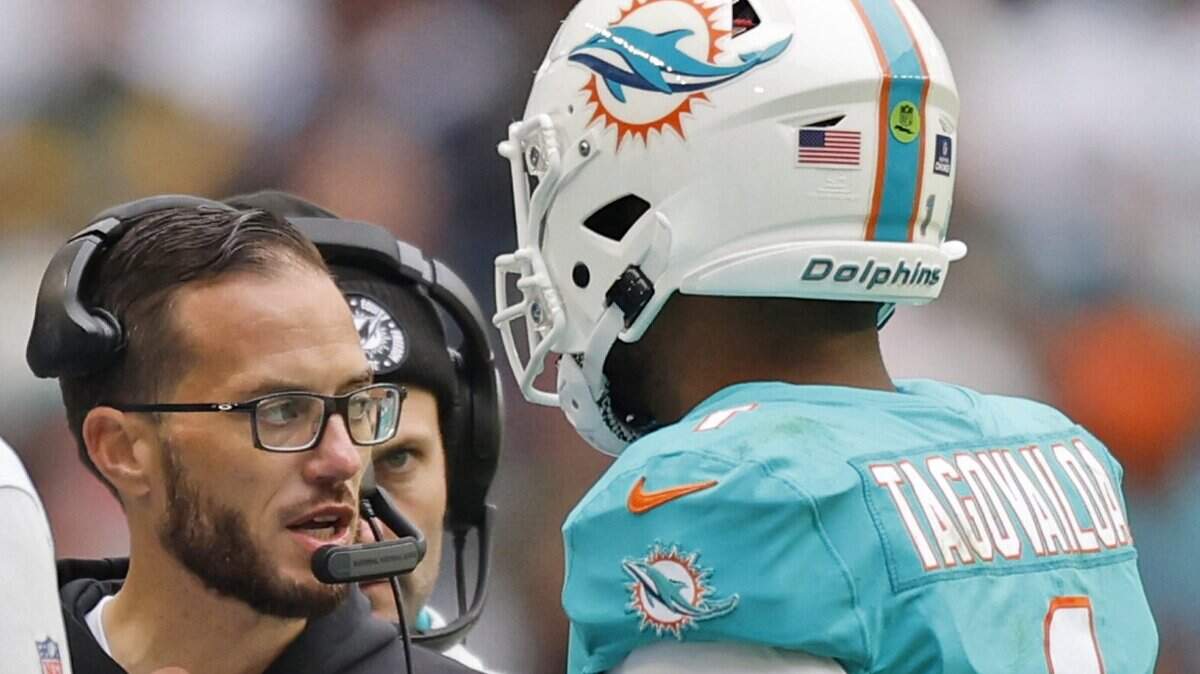 Miami Dolphins head coach Mike McDaniel talks with Miami Dolphins quarterback Tua Tagovailoa (1) in the second quarter during the game against the Green Bay Packers at Hard Rock Stadium in Miami Gardens, Florida on Sunday, December 25, 2022.