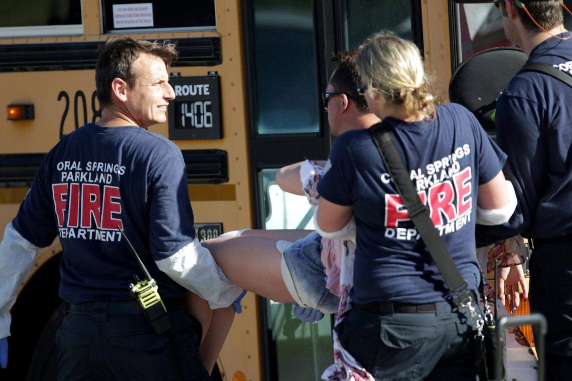 Medical personnel from Coral Springs tend to a victim outside of Stoneman Douglas High School in Parkland after Nikolas Cruz's rampage on Wednesday, Feb. 14, 2018.  A deputy chief for Coral Springs-Parkland Fire Department says paramedics were prevented by the Broward Sheriff's Office from entering the freshman building, where the mass shooting occurred, to treat victims.