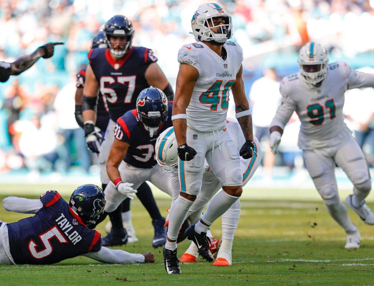 Miami Dolphins defensive back Nik Needham (40) reacts after sacking Houston Texans quarterback Tyrod Taylor (5) during first quarter of an NFL football game at Hard Rock Stadium on Sunday, November 7, 2021 in Miami Gardens, Florida.