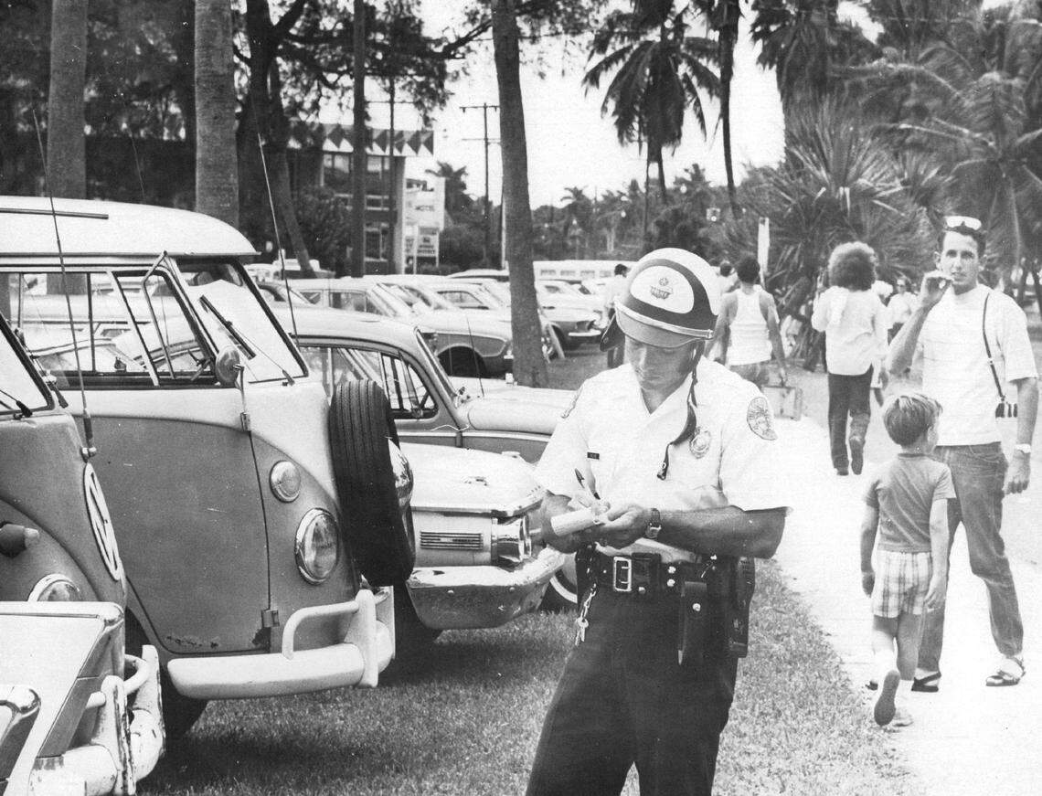 In 1969, a Miami police office issues parking tickets hippie buses along South Bayshore Drive in Coconut Grove