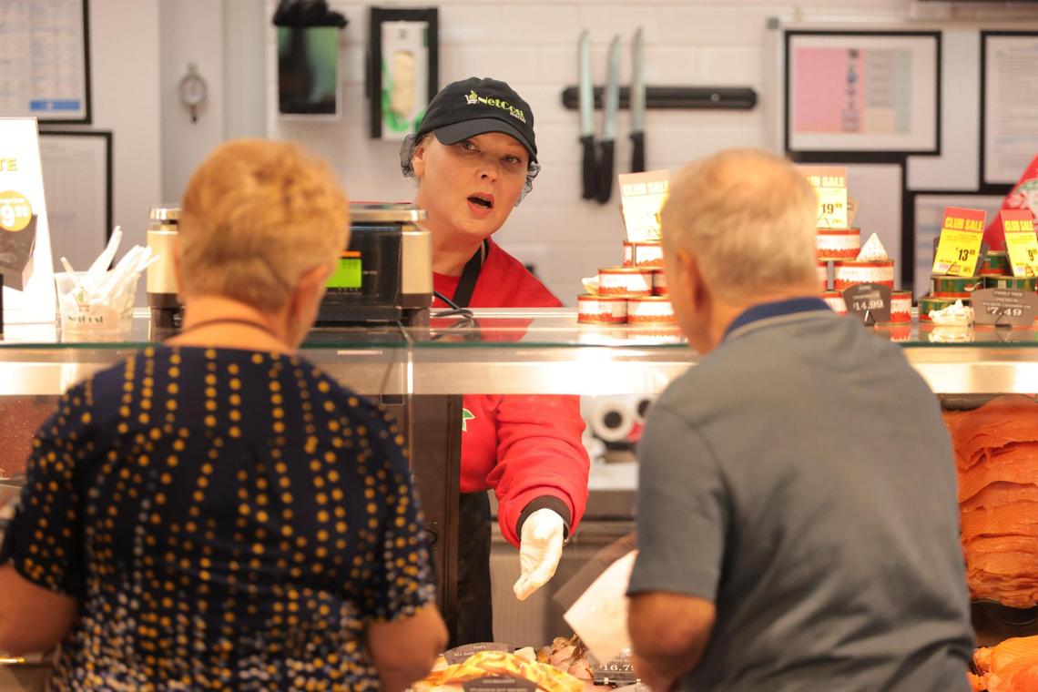 Svetlana Bapavlova takes care of customers at the deli counter at NetCost Market in Hollywood, Florida, on Thursday, Dec. 19, 2024.