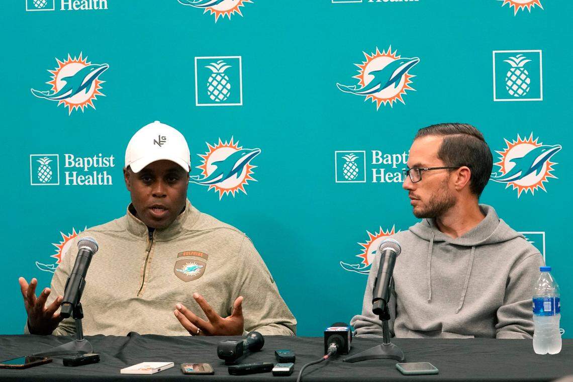 Miami Dolphins general manager Chris Grier, left, and head coach Mike McDaniel, right, respond to questions during a news conference at the NFL football team’s training facility, Monday, Jan. 16, 2023, in Miami Gardens, Fla. (AP Photo/Lynne Sladky)