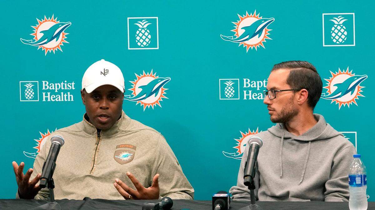 Miami Dolphins general manager Chris Grier, left, and head coach Mike McDaniel, right, respond to questions during a news conference at the NFL football team’s training facility, Monday, Jan. 16, 2023, in Miami Gardens, Fla. (AP Photo/Lynne Sladky)