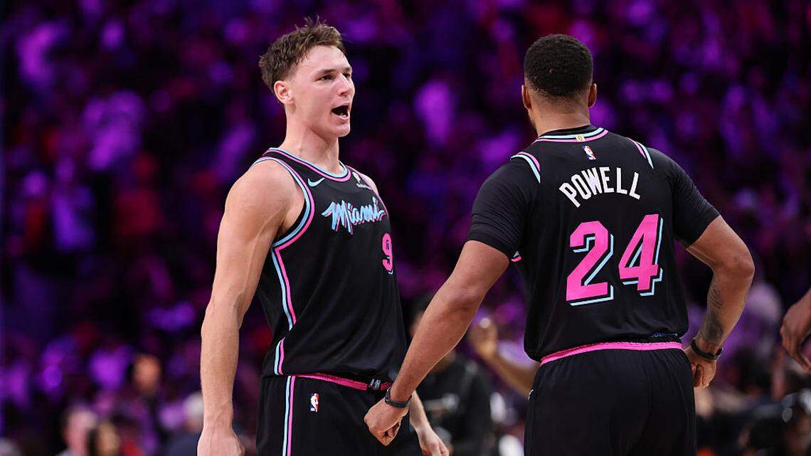 Pelle Larsson #9 reacts with Norman Powell #24 of the Miami Heat against the Oklahoma City Thunder during the second half at Kaseya Center on January 17, 2026 in Miami.