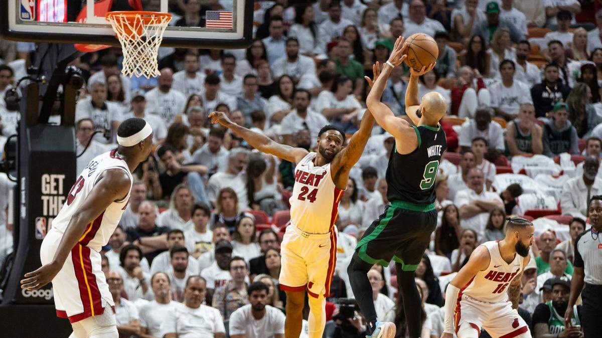 Miami Heat forward Haywood Highsmith (24) defends as Boston Celtics guard Derrick White (9) shoots the ball in the first half of Game 4 of an NBA basketball first-round playoff series at the Kaseya Center on Monday, April 29, 2024, in Miami, Fla.