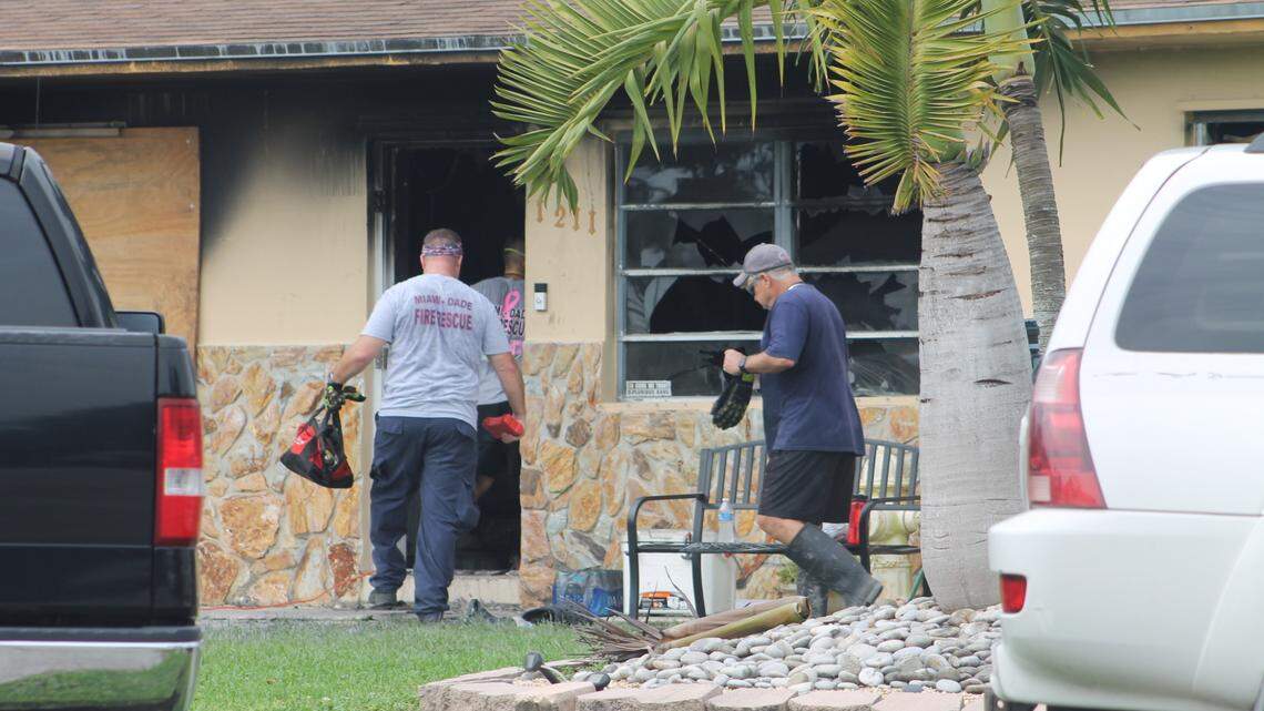 Miami-Dade County firefighters enter a house at Northwest 18th Street in Homestead Wednesday afternoon, Nov. 11, 2020, that that caught fire the day before, killing one woman inside.