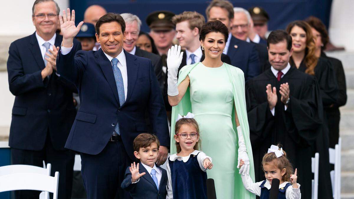 With former Florida Gov. Jeb Bush to the left, Gov. Ron and Casey DeSantis, with their children Mason, Madison and Mamie, wave to the crowd during an inauguration ceremony at the historic Florida Capitol on Jan. 3, in Tallahassee.