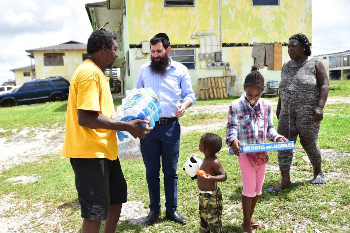 Rabbi Sholom Bluming delivers water and the board game Chutes and Ladders to families in Freeport in the days after Hurricane Dorian hit the island nation on Sept. 1, 2019.
