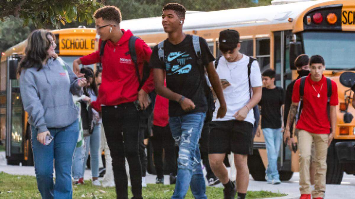 Students enter campus from the bus loop on the first day of school at Miami Beach High in Miami Beach, Florida on Aug. 17, 2022.