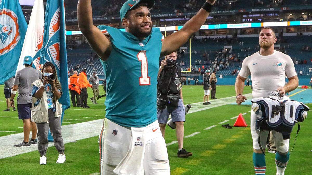 Miami Dolphins quarterback Tua Tagovailoa (1) walks off the field in celebration after defeating the New England Patriots at Hard Rock Stadium in Miami Gardens on Sunday, January 9, 2022.