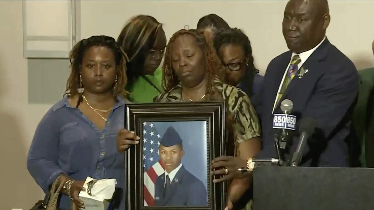 Mika Fortson, the mother of Senior Airman Roger Fortson, holds a photo of her son as civil rights attorney Ben Crump speaks to reporters last week. Roger Fortson, 23, was shot and killed by a Okaloosa County (Fla.) Sheriff’s deputy responding to a disturbance call.