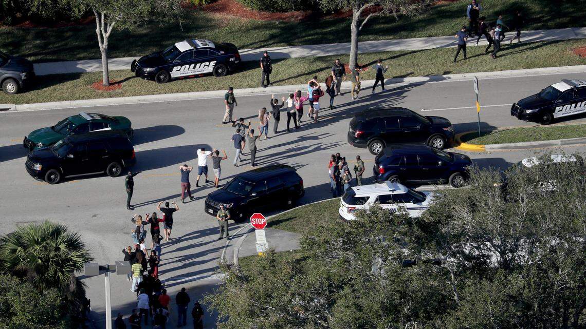 Police evacuate students from Marjory Stoneman Douglas High School in Parkland after a shooting on Feb. 14, 2018.