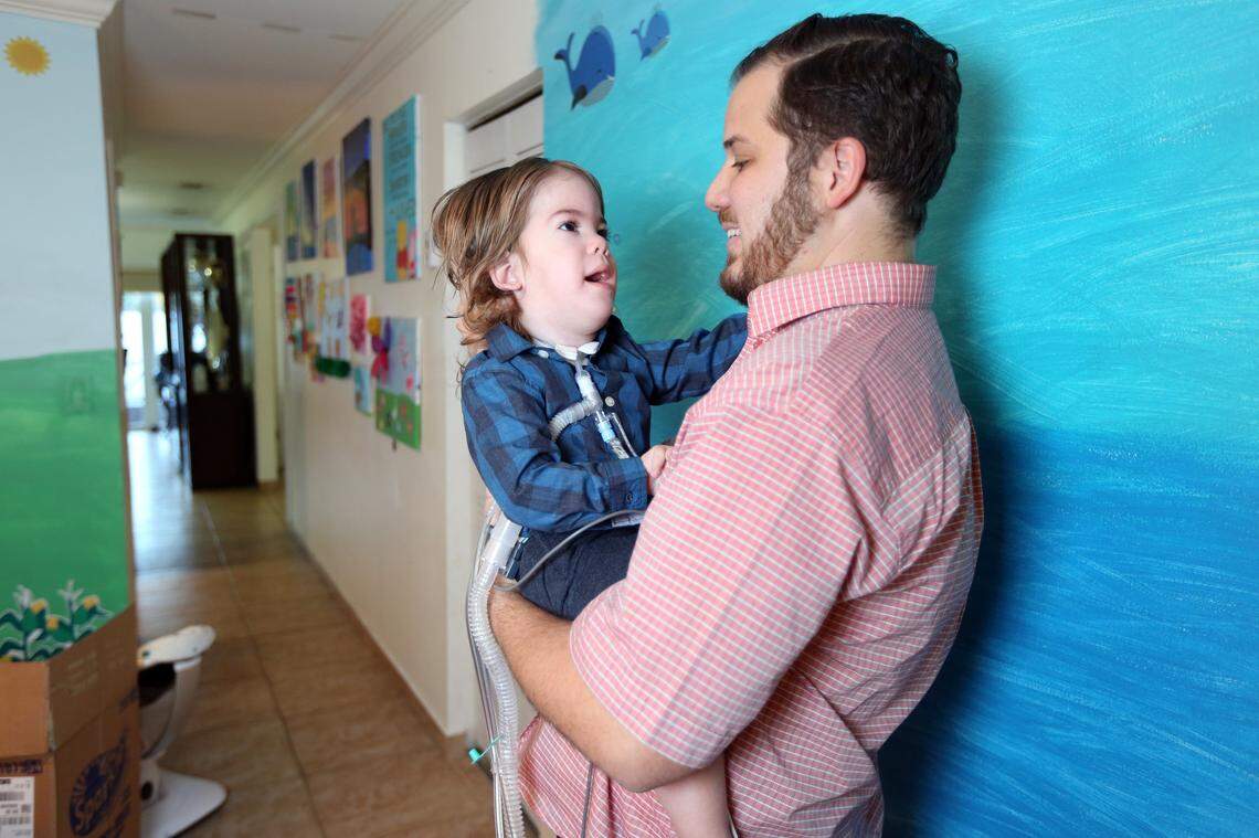 JJ (Joshua Jacob), then 20 months old, smiles at his father, Javier Gonzalez, as Gonzalez plays with him in their home on Nov. 24, 2017.