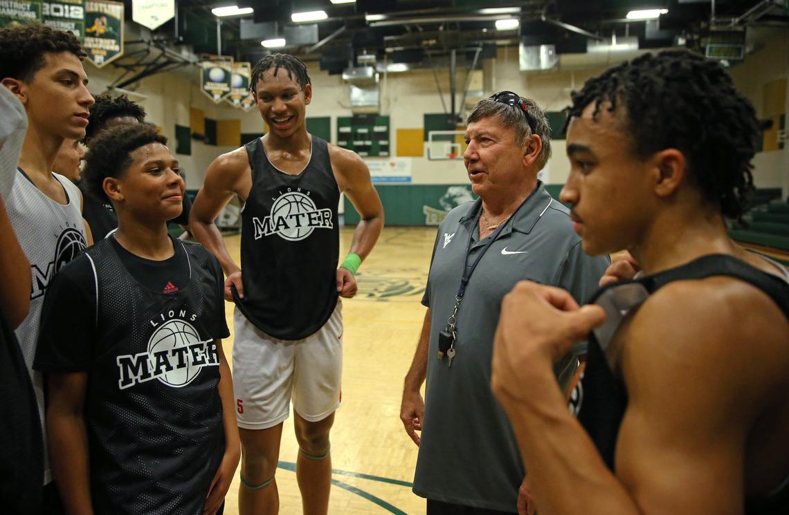 Mater Academy Malik Reneau (5) smiles as Mater Academy basketball coach Shakey Rodriguez talks to his team during practice at Mater Academy on Wednesday, November 13, 2019 in Hialeah Gardens.
