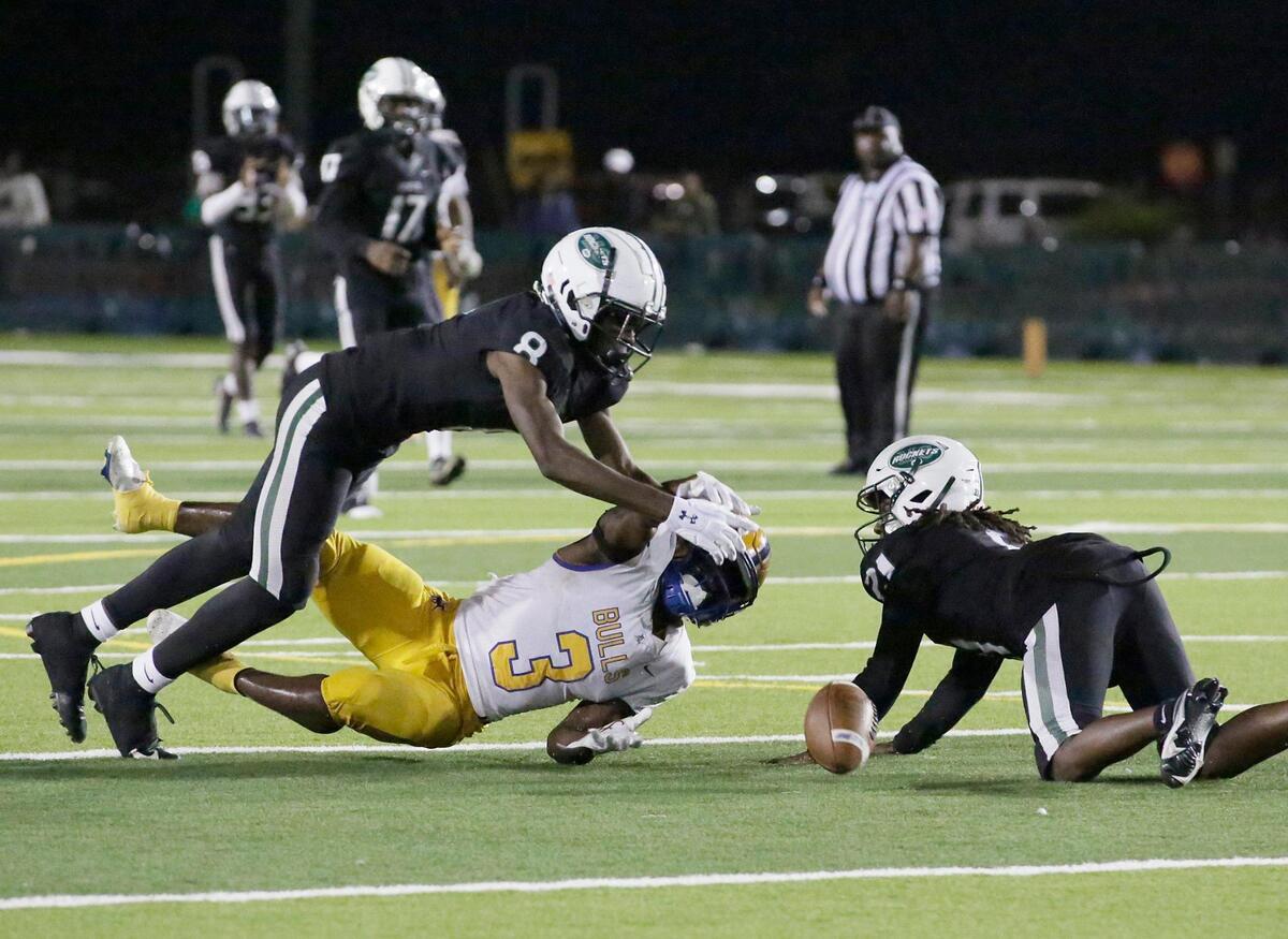 Miami Central Rockets defenders take down Northwestern Bulls running back Jamari Ford (3) during Region 4-2M semifinal playoff football game on Friday, November 18, 2022 at Traz Powell Stadium in Miami. Andrew Uloza / for Miami Herald