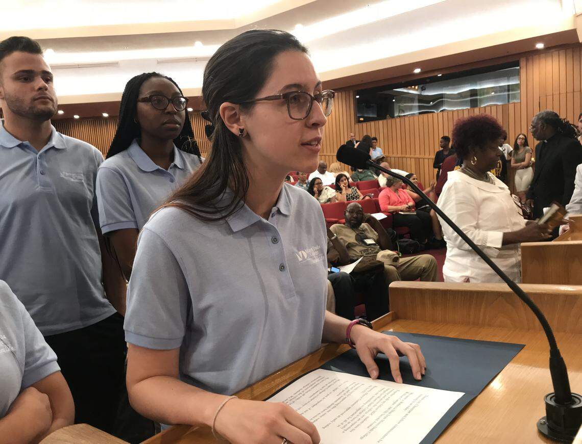 Miami Dade College student Rebecca Diaz urges the Miami-Dade Commission to bring an early-voting site to the community college. Behind her are MDC students Christian Rosquete and Jaqua’Jah Frederick.