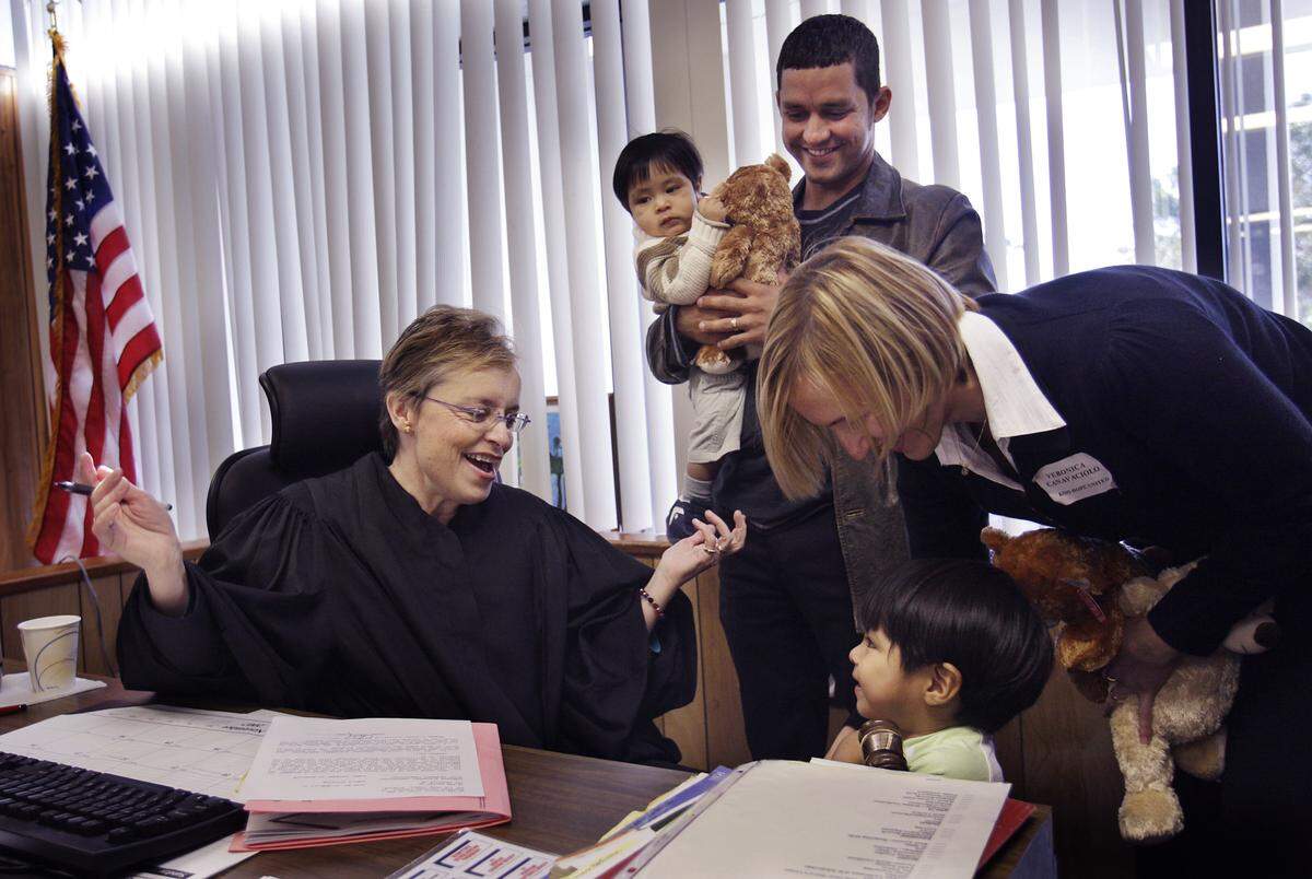 Judge Cindy Lederman allows 2-year-old Yonathan Canavaciolo to bang her gavel after she finalized his adoption and that of his brother, Brian,1, by Jose and Veronica Canavaciolo. The proceedings took place at the Juvenile Justice Center as part of National Adoption Day 2007.