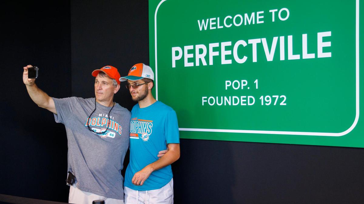 Fans taking selfies in one of the stations at the 1972 perfect season museum exhibit are one of many activities to commemorate the 50th Anniversary of the 1792 perfect season before the start of an NFL football game between the Miami Dolphins against the Buffalo Bills at Hard Rock Stadium on Sunday, September 25, 2022 in Miami Gardens, Florida.