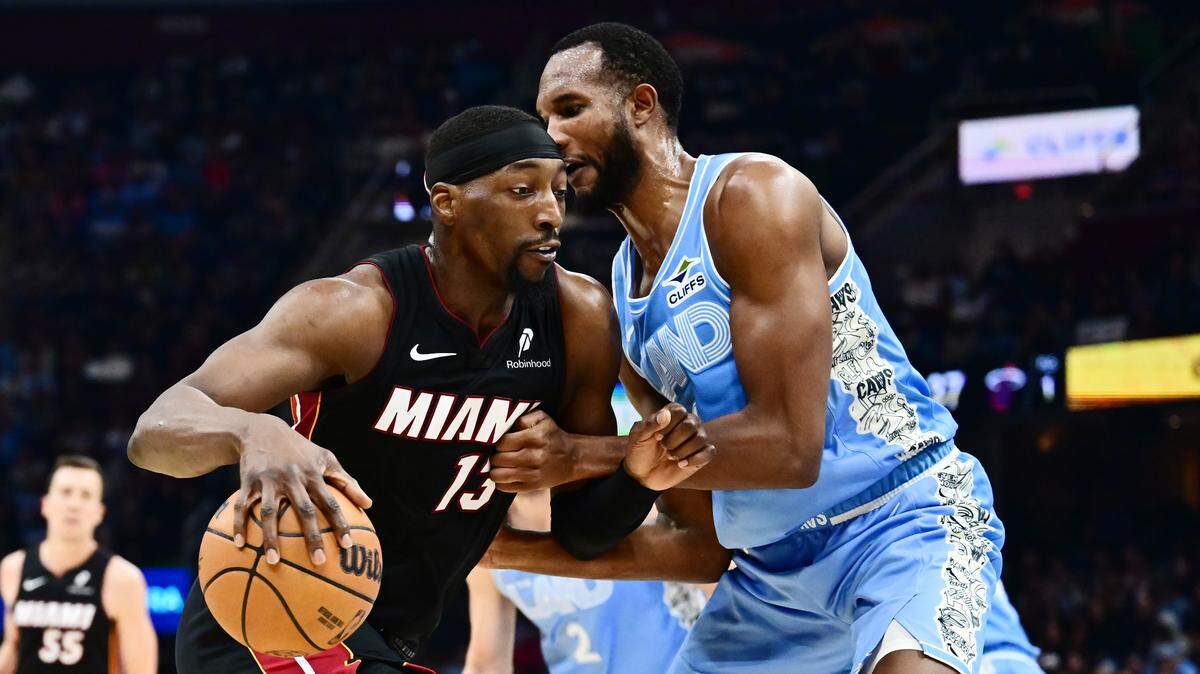 Miami Heat center Bam Adebayo (13) drives to the basket against Cleveland Cavaliers forward Evan Mobley (4) during the first half at Rocket Arena.